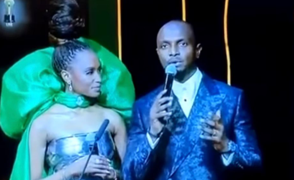 IK Osakioduwa on stage with his co-host Zozibini Tunzi during 9th AMVCA, 2023